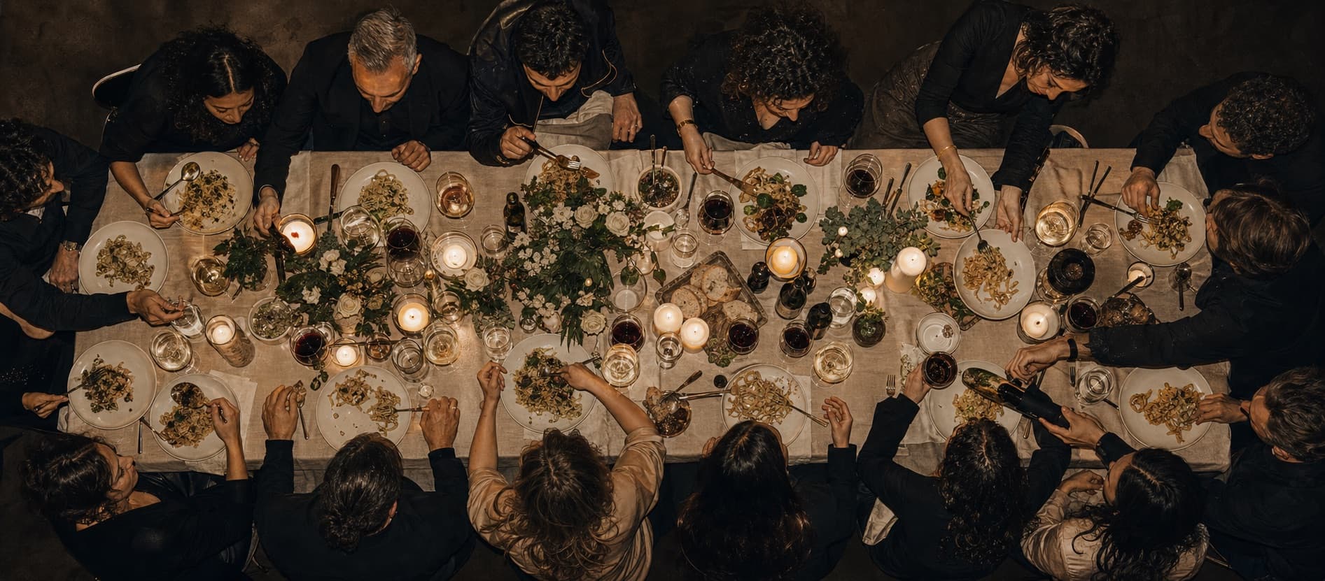 A long table in Amsterdam seen from above, set for a full house of dinner guests.